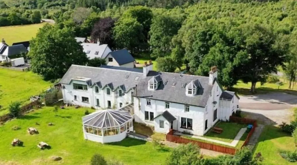 an aerial view of a large white house at River Black Water inn in Garve