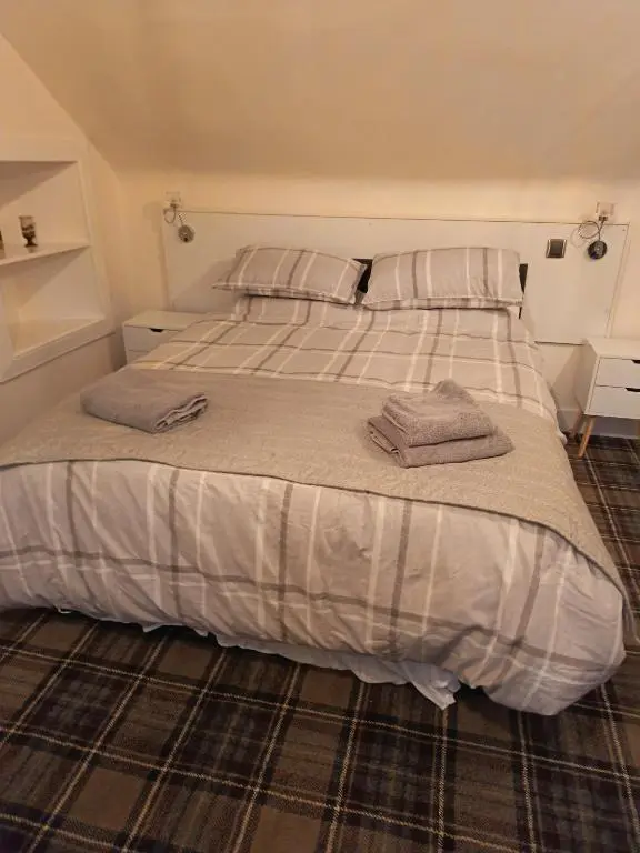 a bed with two pillows on it in a bedroom at River Black Water inn in Garve