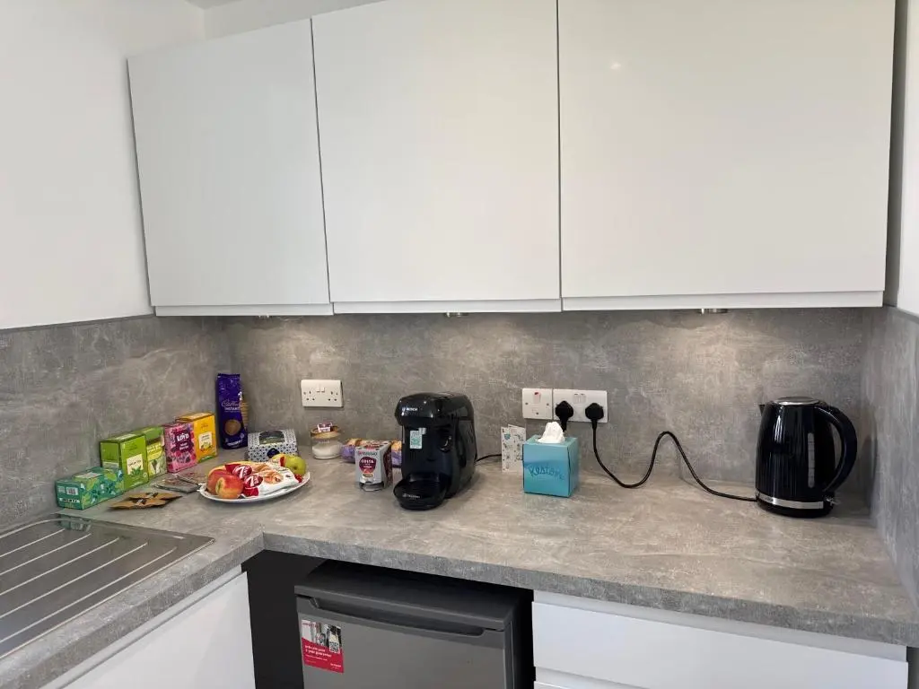 a kitchen counter top with a coffee maker on it at Altons Bothy Guest House