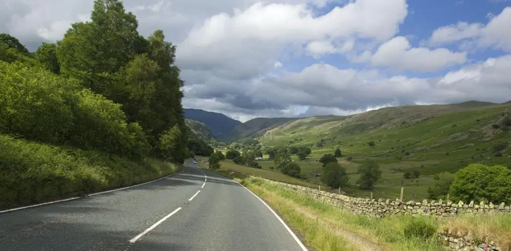 an empty road in the middle of a valley at Biallid House in Newtonmore