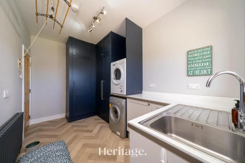 a kitchen with a sink and a washing machine at Woodside, Get away with Hot Tub, near Fraserburgh in Strichen