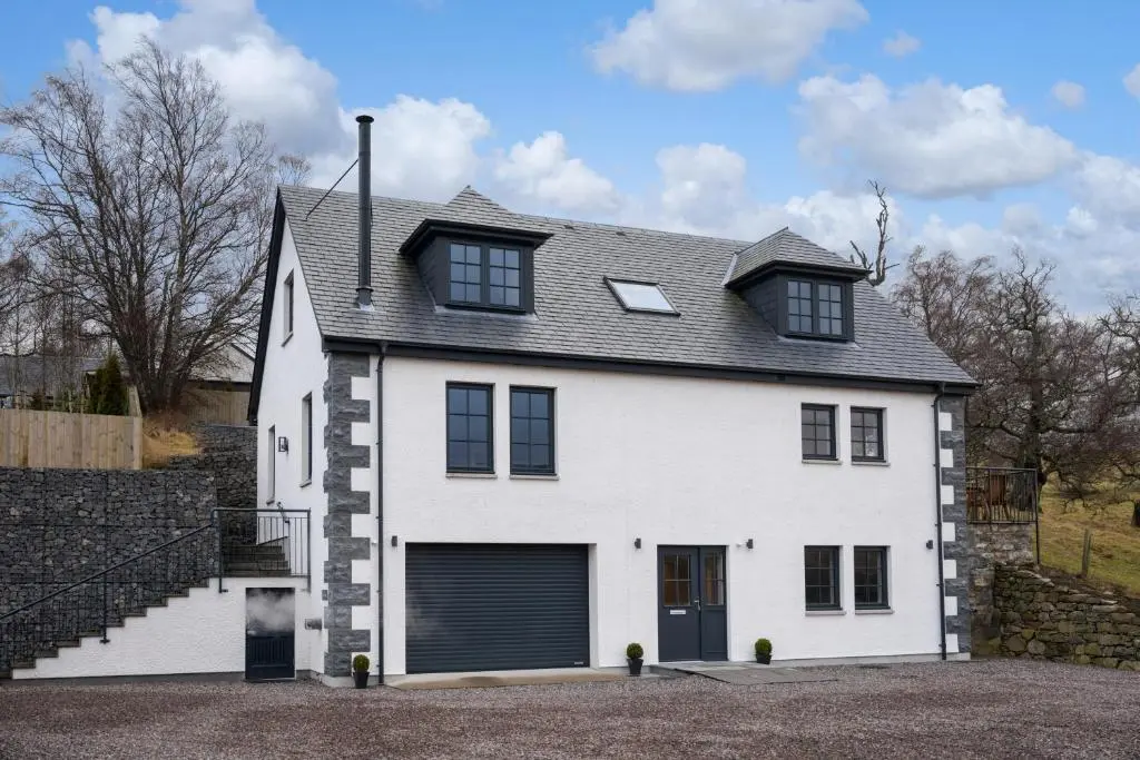 a white house with a black roof at Glenview in Tomatin