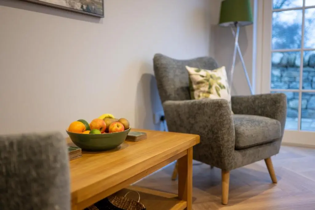 a living room with a bowl of fruit on a table at Glenview in Tomatin