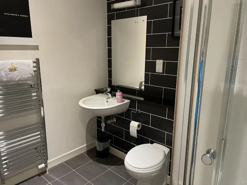 a bathroom with a toilet and a sink at Romantic getaway at St Andrew's Chapel in Fort Augustus