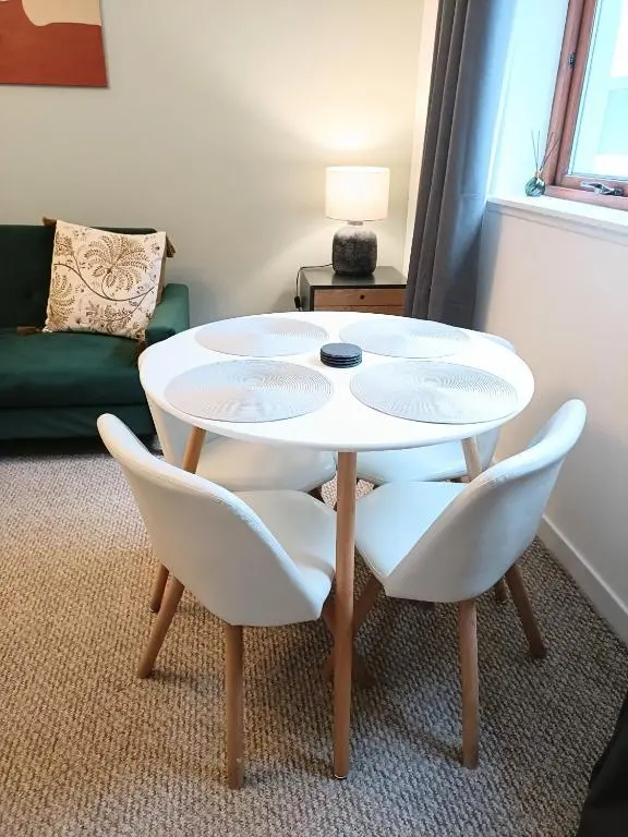 a white table and chairs in a living room at Central City Apartment - Inverness centre in Inverness