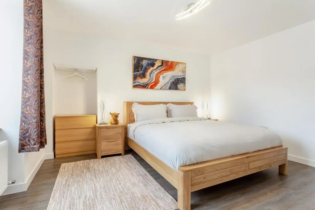 a bedroom with a bed with a wooden bed frame at 2 Bed in Inverness oc-b32706 in Inverness