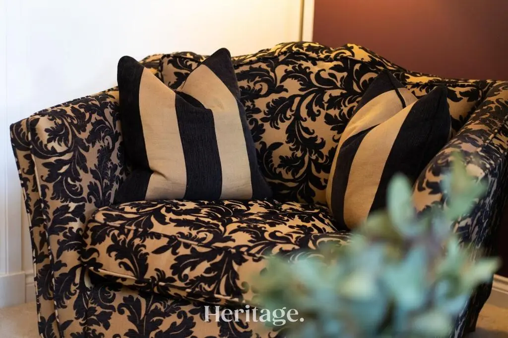 a black and white couch with pillows on it at Bonnieview House, Tarves, Aberdeenshire