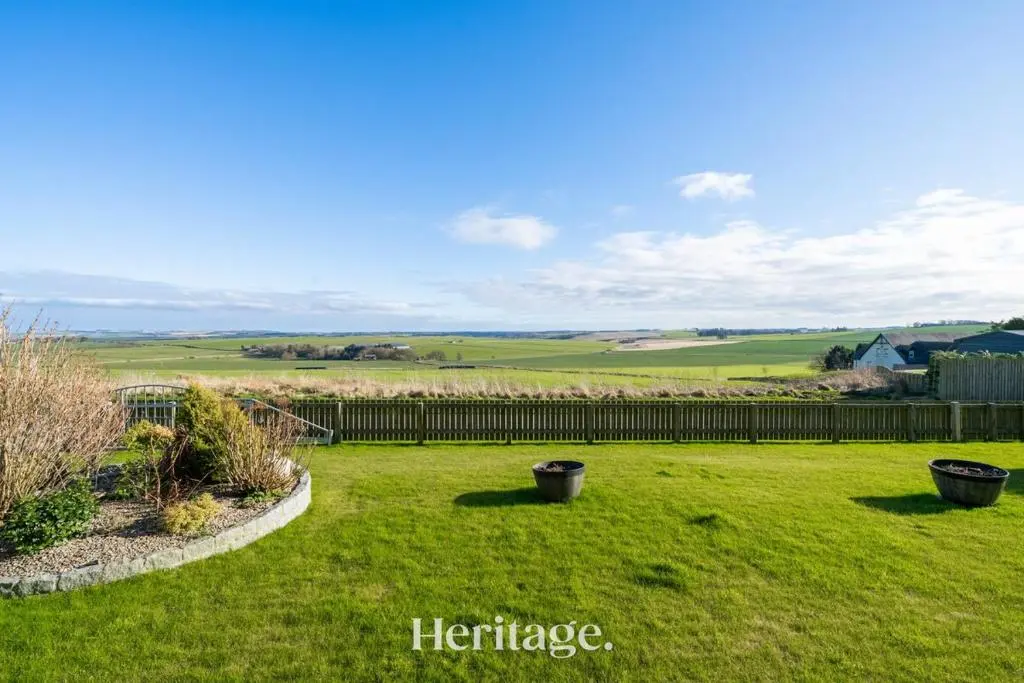 a yard with two trash cans in the grass at Bonnieview House, Tarves, Aberdeenshire