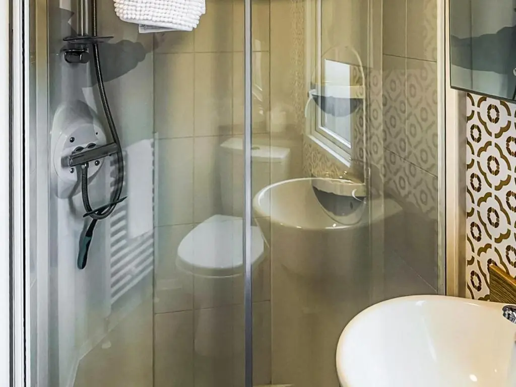 a bathroom with a shower with a toilet and a sink at Lodge 58 in Aviemore
