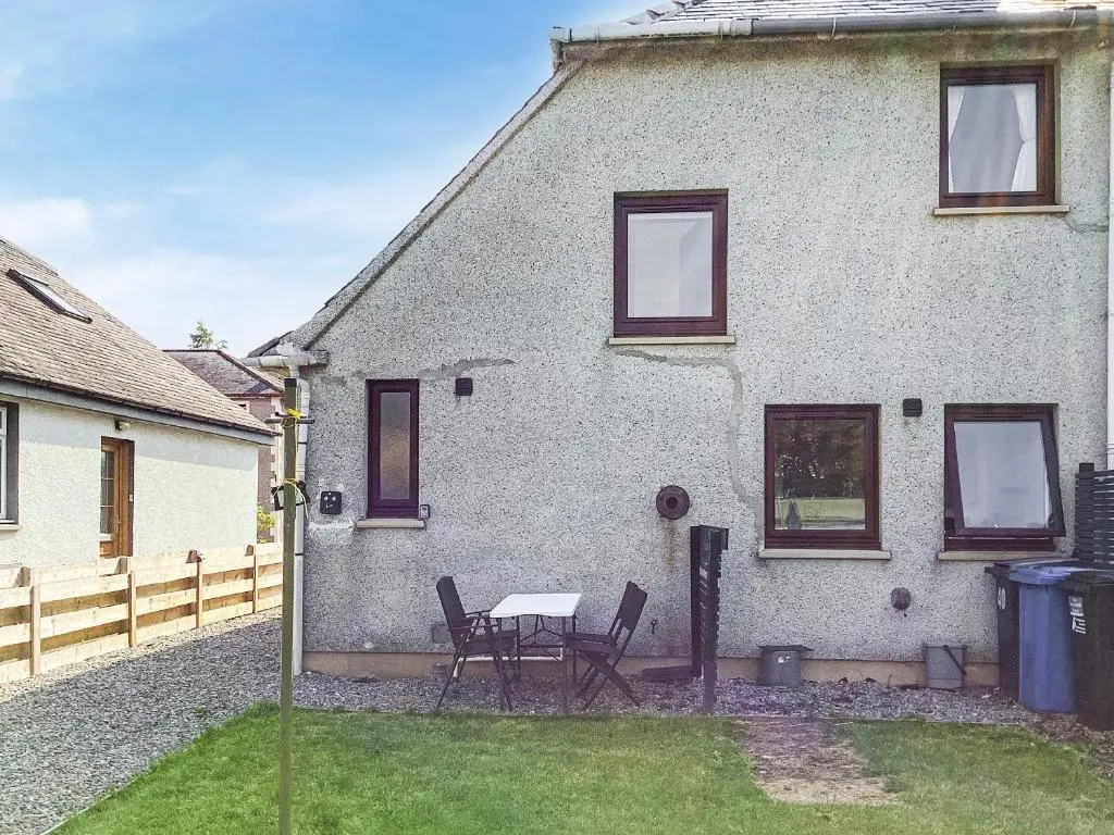 a house with a table and chairs in the yard at Amayrah Cottage in Inverness