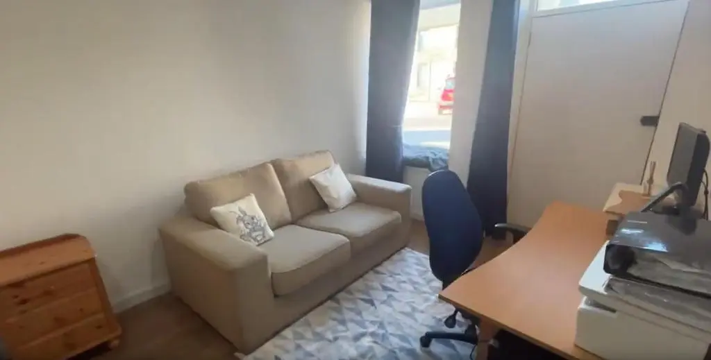 a living room with a couch and a desk at White Crystal in Invergordon