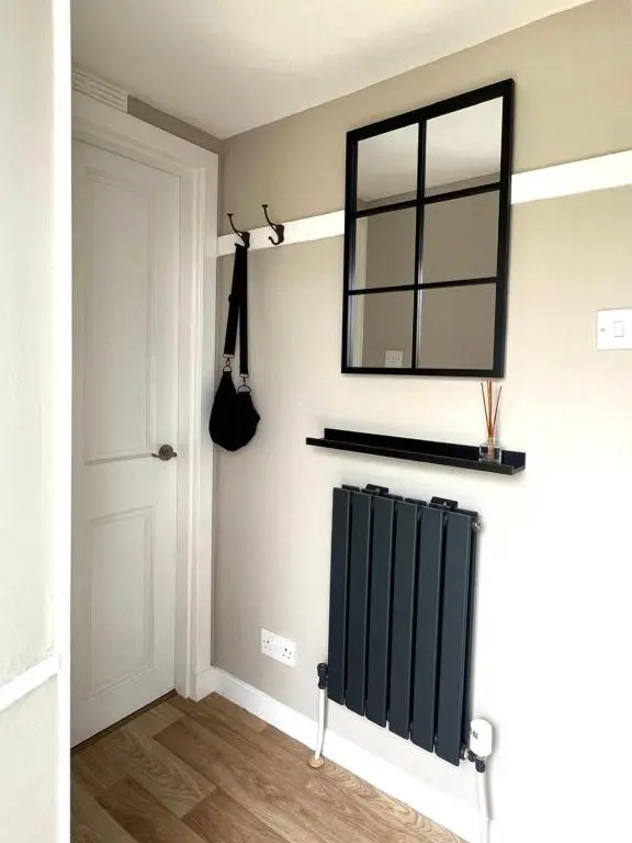 a mirror on a wall next to a door at Seatown Cottage - Stone's throw from beach in Lossiemouth