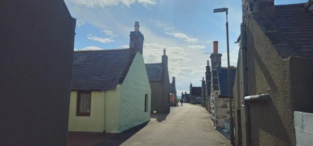 a narrow alley with buildings on a street at Coastal Bliss, Rosehearty, Fraserburgh in Rosehearty
