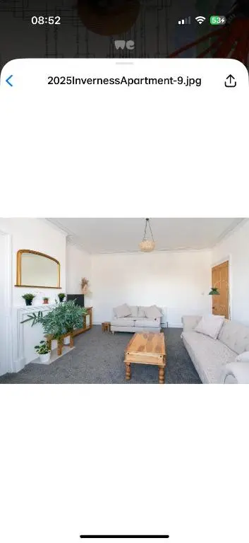 a living room with a couch and a table at Hawthorn villa in Dalneigh