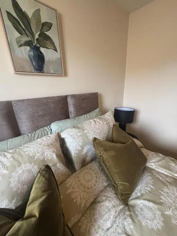 a bed with pillows on it in a room at Number Sixteen in Kildary
