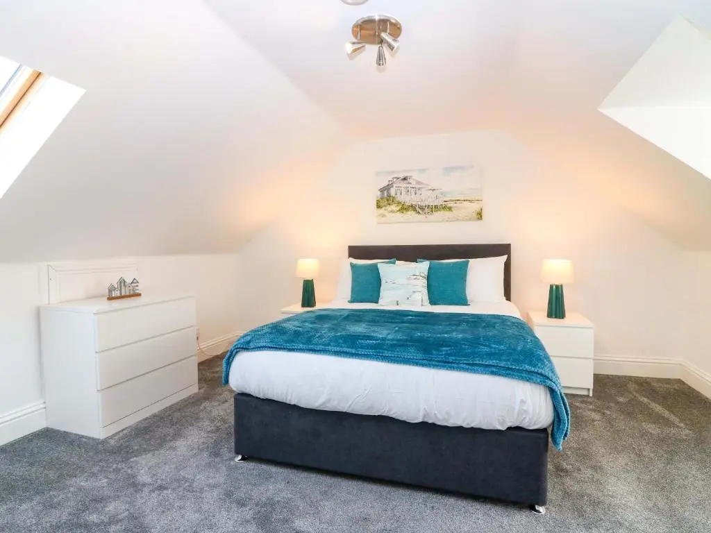 a bedroom with a bed and two night stands at No 9 North St in Fraserburgh