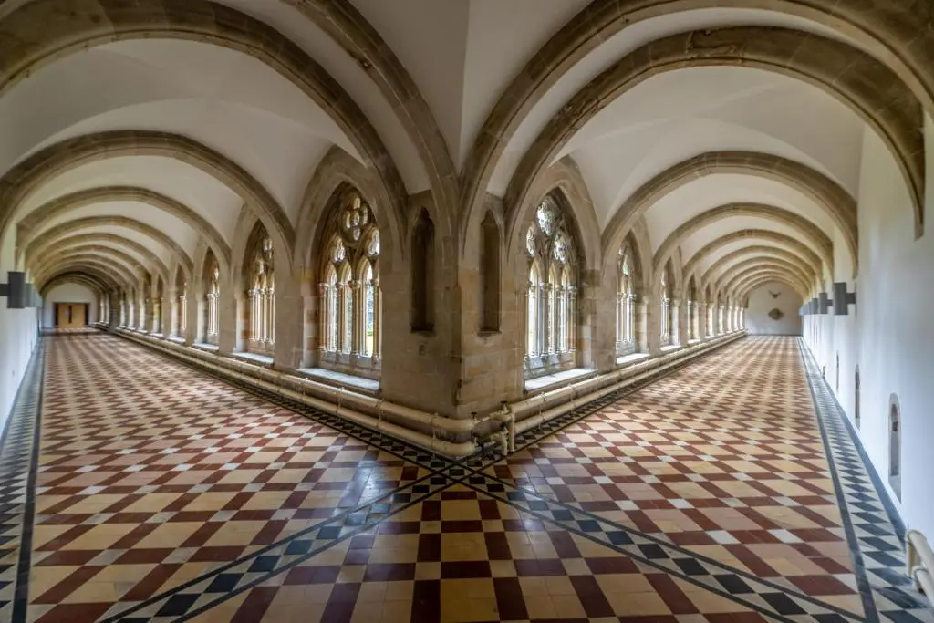 an arcade in a building with a checkerboard floor at The Livingstone Loch Ness OS9 in Fort Augustus