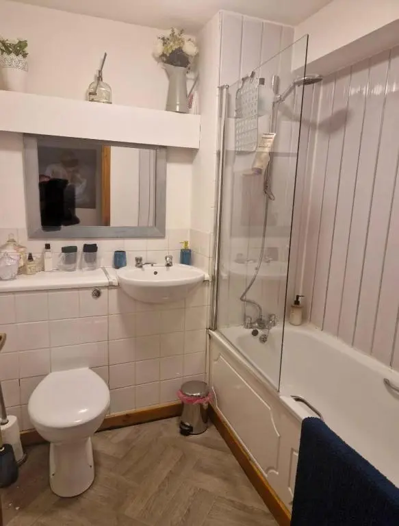 a bathroom with a toilet and a sink and a shower at Bright 2 Bed Corner Flat - Great Location in South Kessock