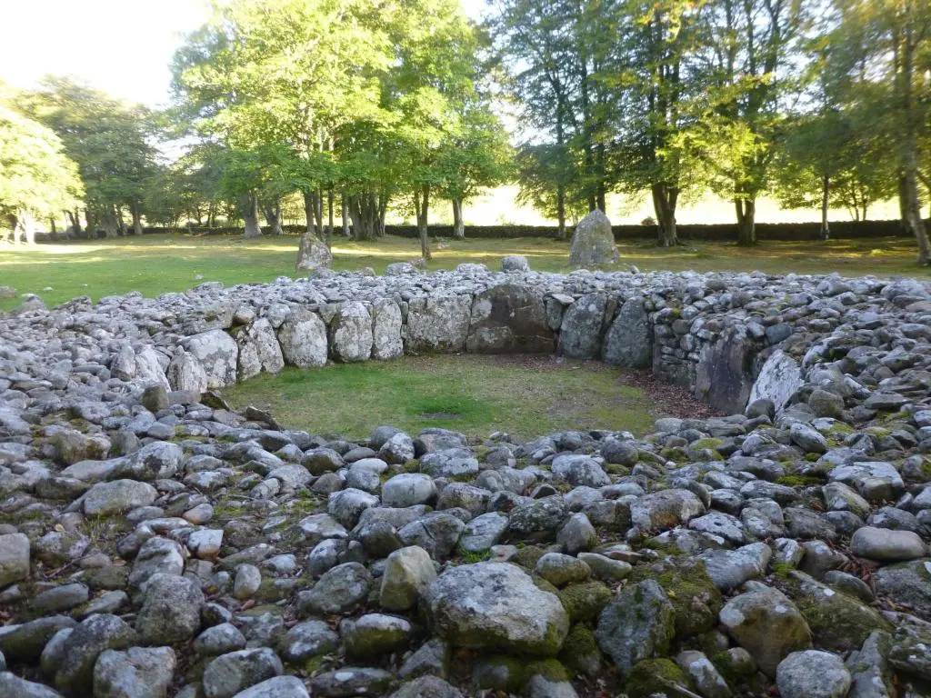 a rock wall with a hole in the middle at By the Brae in Inverness