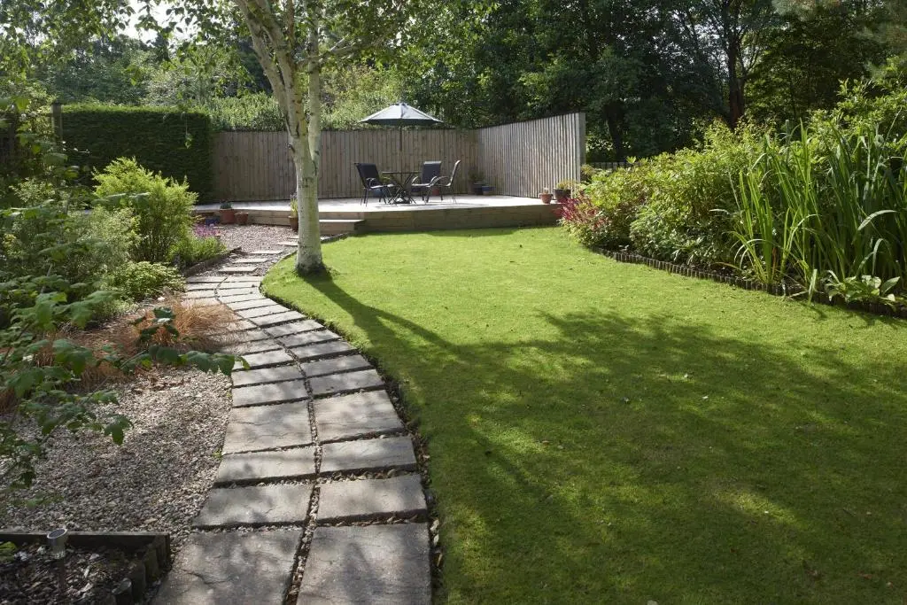 a garden with a walkway and a tree in the yard at By the Brae in Inverness