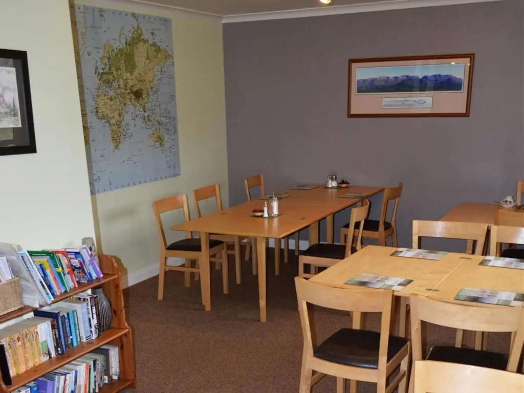 a classroom with tables and chairs and a map on the wall at Carn Mhor Bed and Breakfast in Aviemore