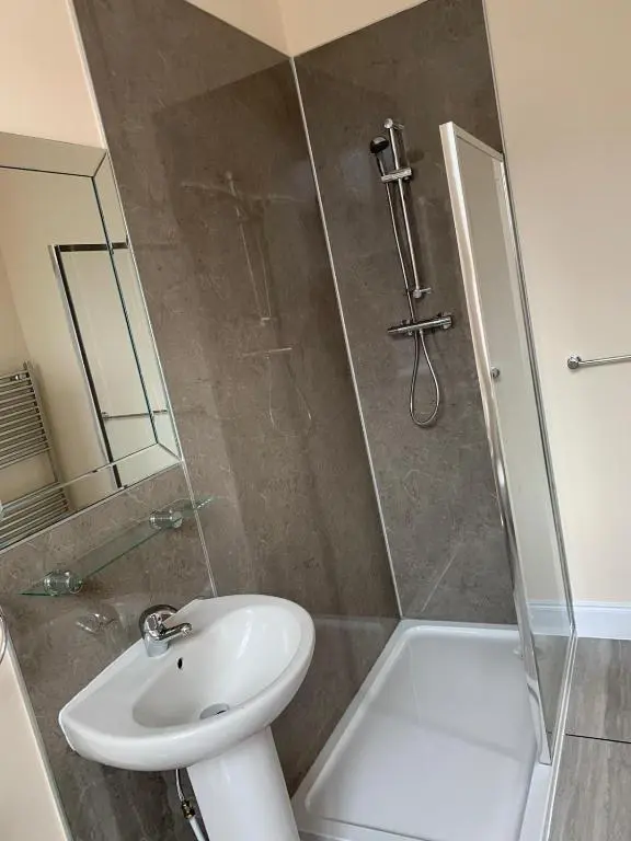 a bathroom with a shower and a sink and a toilet at Royal Hotel in Dingwall