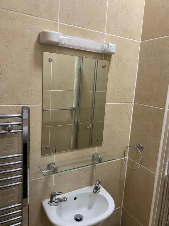 a bathroom with a sink and a mirror at Royal Hotel in Dingwall