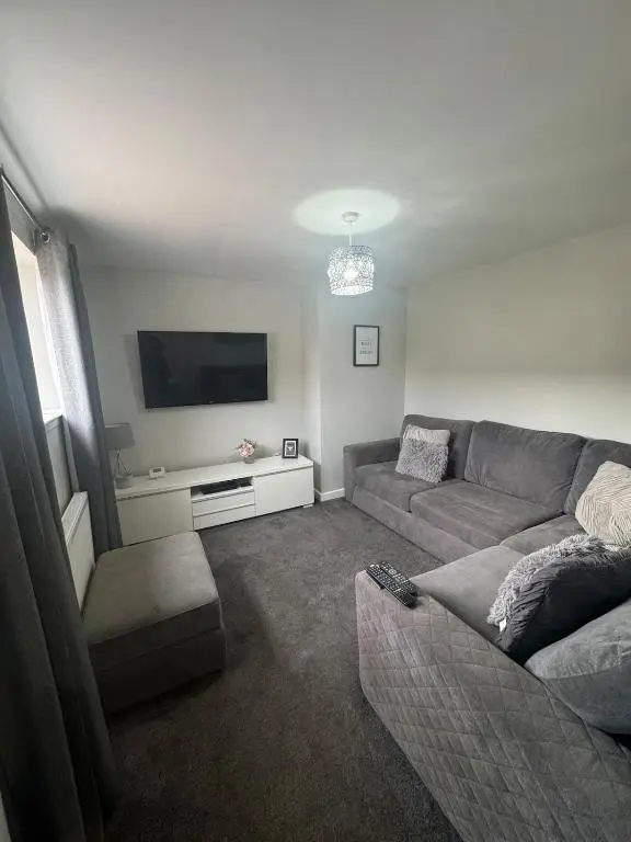 a living room with a couch and a flat screen tv at Inward Oasis Relax and unwind in Buckie
