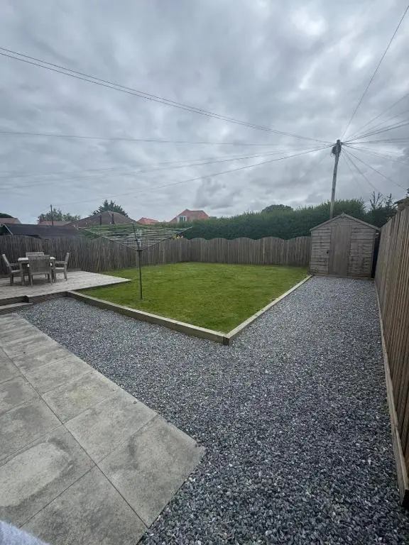 a backyard with a fence and a table and a yard at Inward Oasis Relax and unwind in Buckie