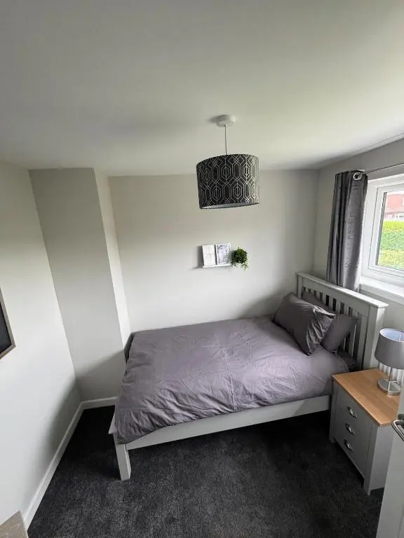 a small bedroom with a bed and a window at Inward Oasis Relax and unwind in Buckie