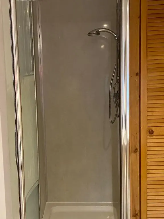 a shower with a glass door in a bathroom at Wee Braemoray, Portessie, Buckie,Moray in Portessie