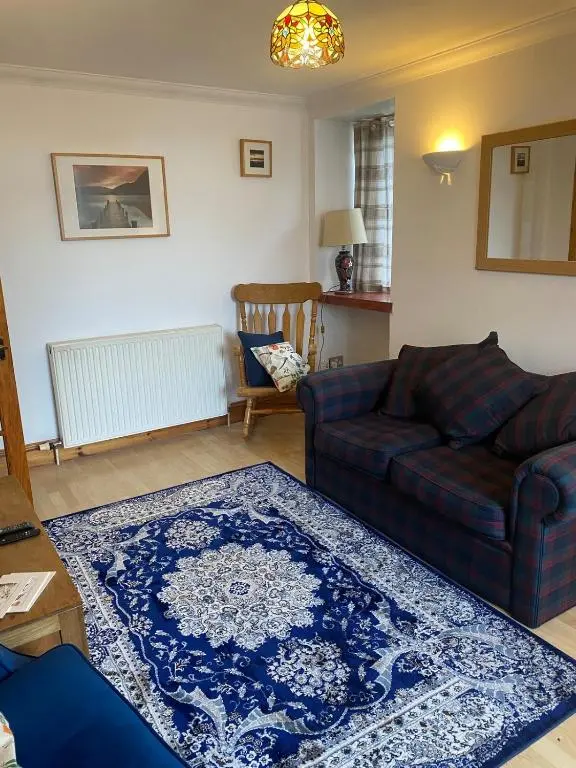 a living room with a couch and a rug at Wee Braemoray, Portessie, Buckie,Moray in Portessie