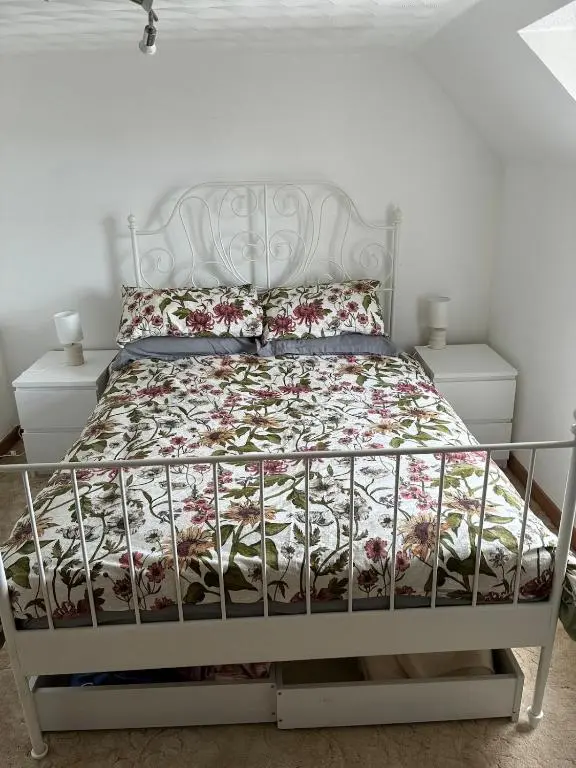 a bedroom with a bed with a white bed frame at Wee Braemoray, Portessie, Buckie,Moray in Portessie