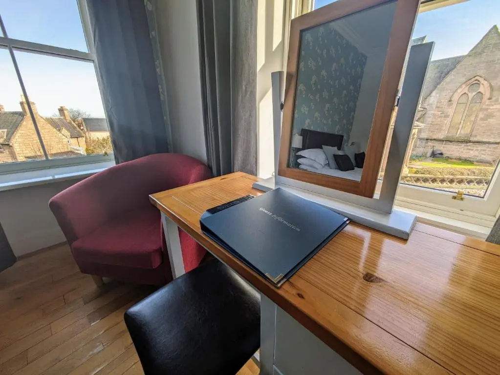 a room with a desk with a laptop on it at The Havelock in Nairn