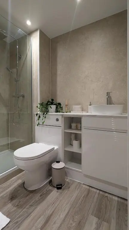 a bathroom with a toilet and a sink and a shower at The Wee Heilan' Drochaid in Inverness