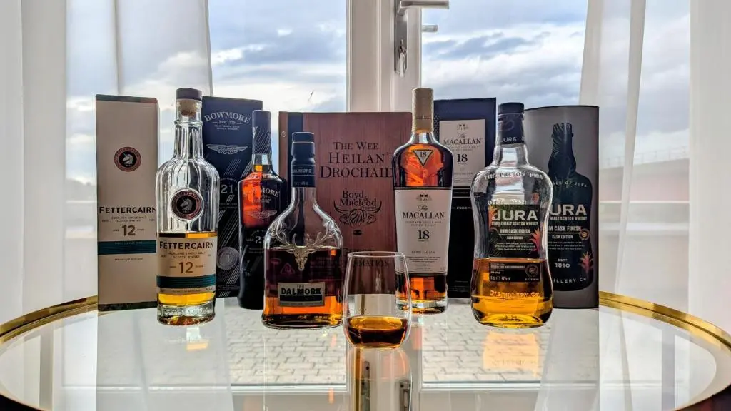 a group of bottles of alcohol sitting on a glass table at The Wee Heilan' Drochaid in Inverness