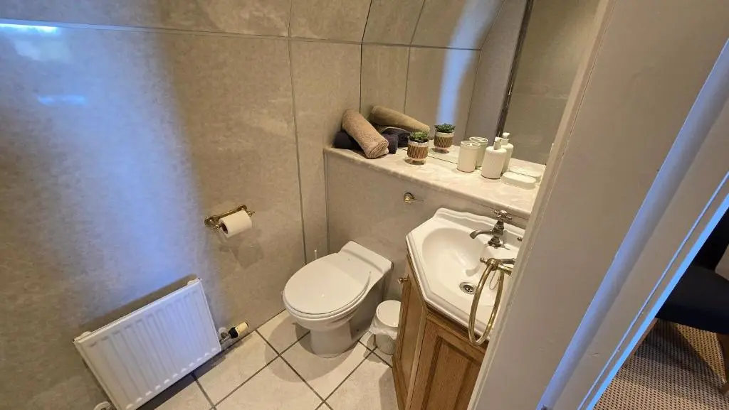 a small bathroom with a toilet and a sink at The Pitfour Arms Hotel in Mintlaw