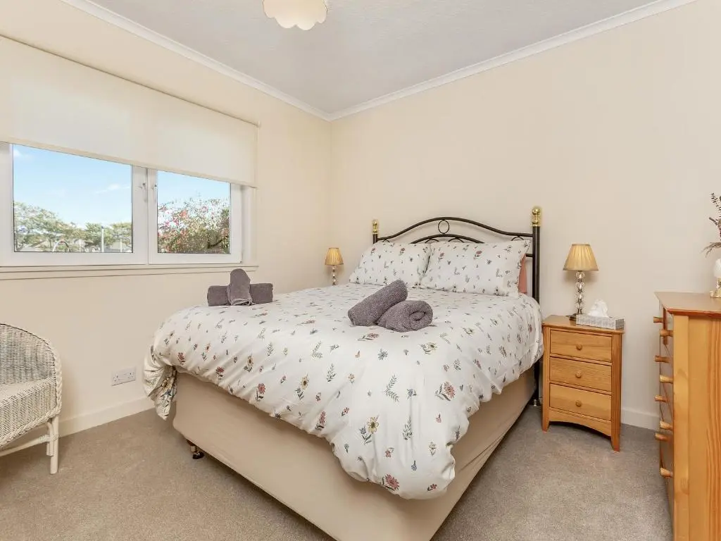 a bedroom with a bed and a window at Tanera in Wick