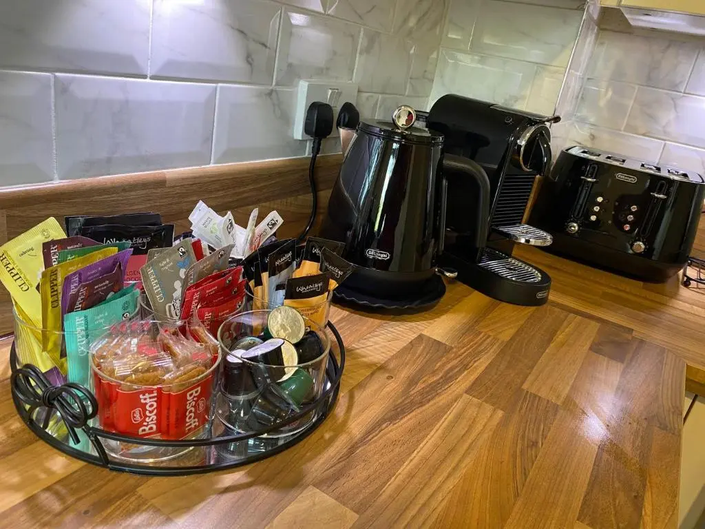 a counter top with a basket of food and a coffee maker at travelNess Apartment in Inverness
