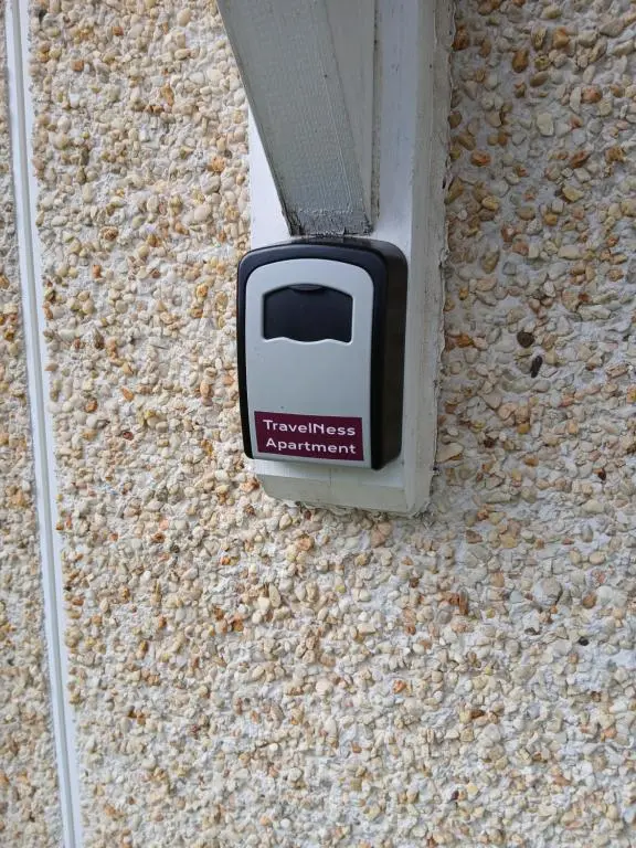 a television embedded in the side of a building at travelNess Apartment in Inverness