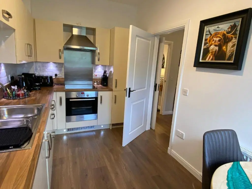 a kitchen with a sink and a counter at travelNess Apartment in Inverness