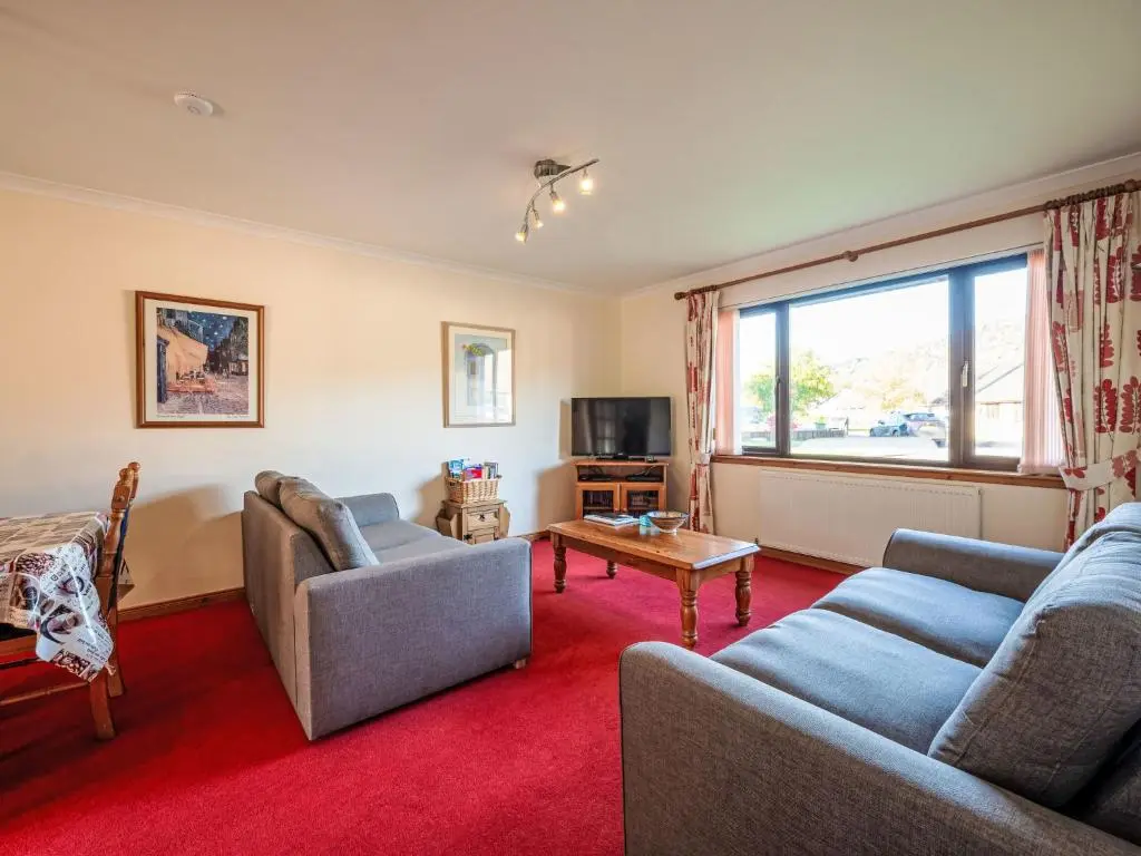 a living room with two couches and a window at Holiday Home Coiltie House by Interhome in Drumnadrochit