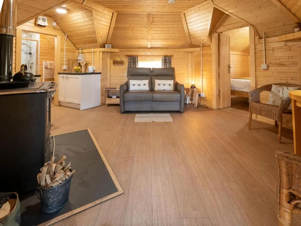 a living room with a couch and a kitchen at Apartment Birch Bothy by Interhome in Coldstone