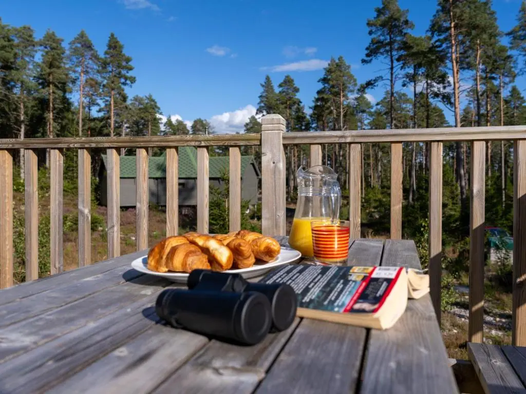 a plate of croissants and orange juice on a wooden table at Apartment Birch Bothy by Interhome in Coldstone