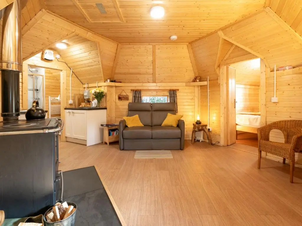 a living room with a couch and a kitchen at Apartment Hazel Bothy by Interhome in Coldstone