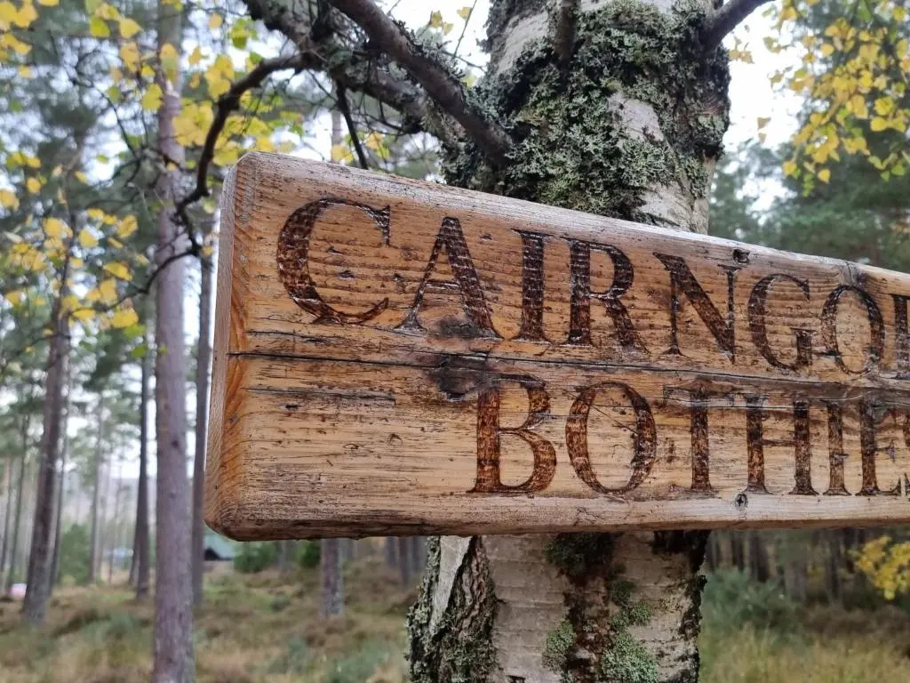 a sign attached to a tree in a forest at Apartment Hazel Bothy by Interhome in Coldstone