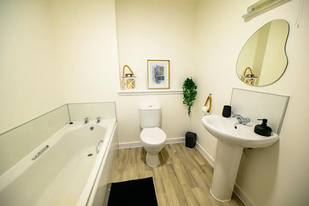 a bathroom with a tub and a toilet and a sink at 2 Bed Property, Beauly in Beauly