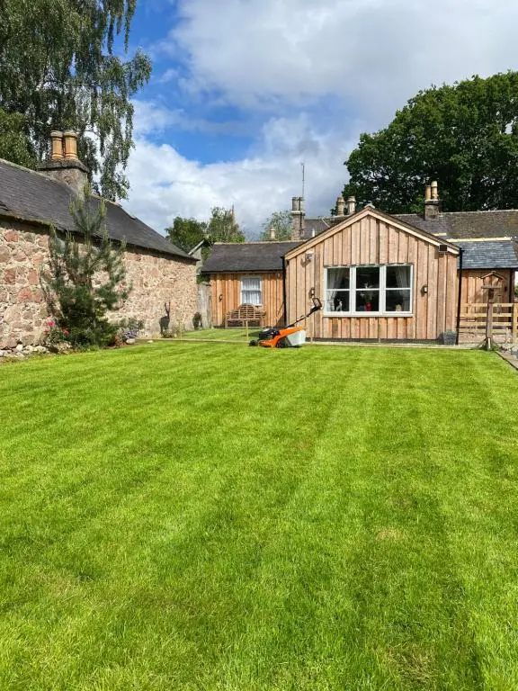 a large lawn in front of a house at Struan Cottage in Ballater
