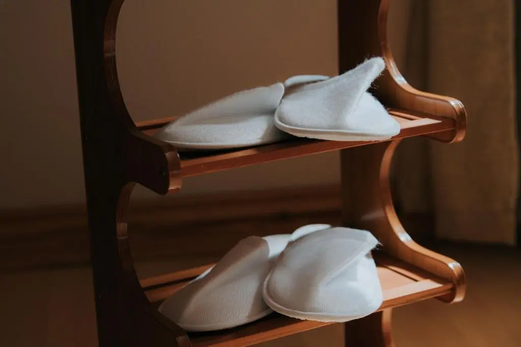 a group of white shoes on a wooden shelf at Spacious Flat with Parking Great Inverness Base in Inverness