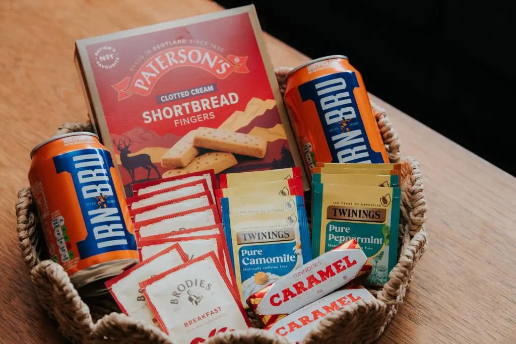 a basket filled with snacks and a book on a table at Spacious Flat with Parking Great Inverness Base in Inverness